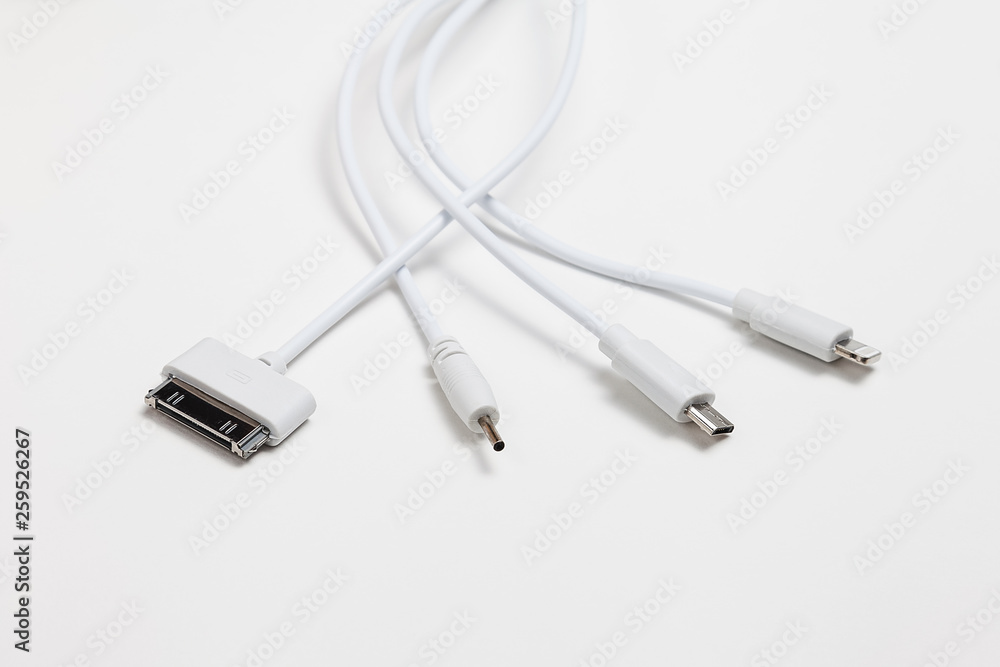 white universal charging cable, adapter with micro USB, usb connectors for different models of phones and devices on a white background white universal charging cable, adapter with micro USB, usb connectors for different models of phones and devices on a white background