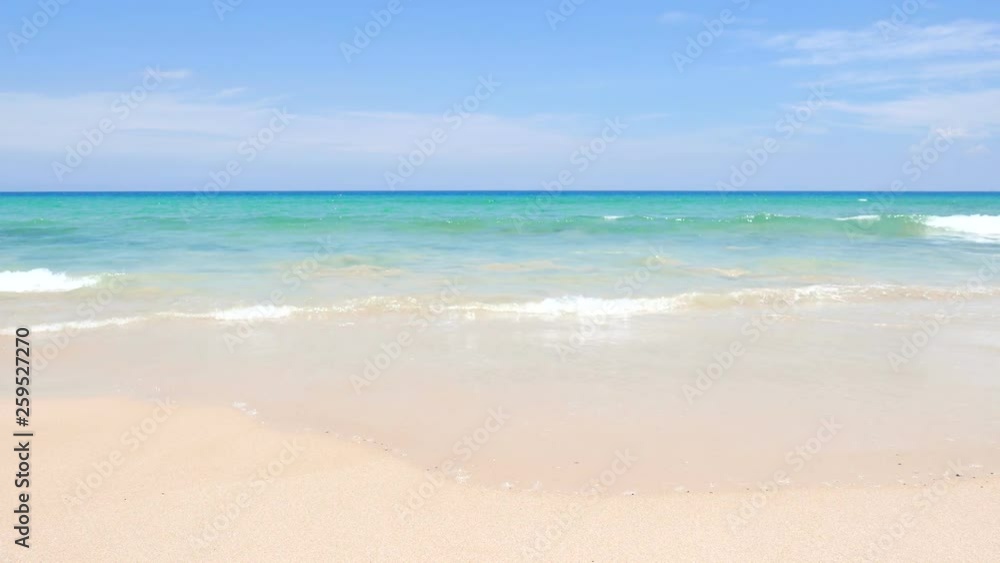 Tropical beach shoreline with waves breaking onto a golden sandy beach Tropical beach shoreline with waves breaking onto a golden sandy beach