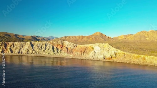 Aerial sidewards dolly, coastline near Mulege, with large cliffs and beautiful sea. photo