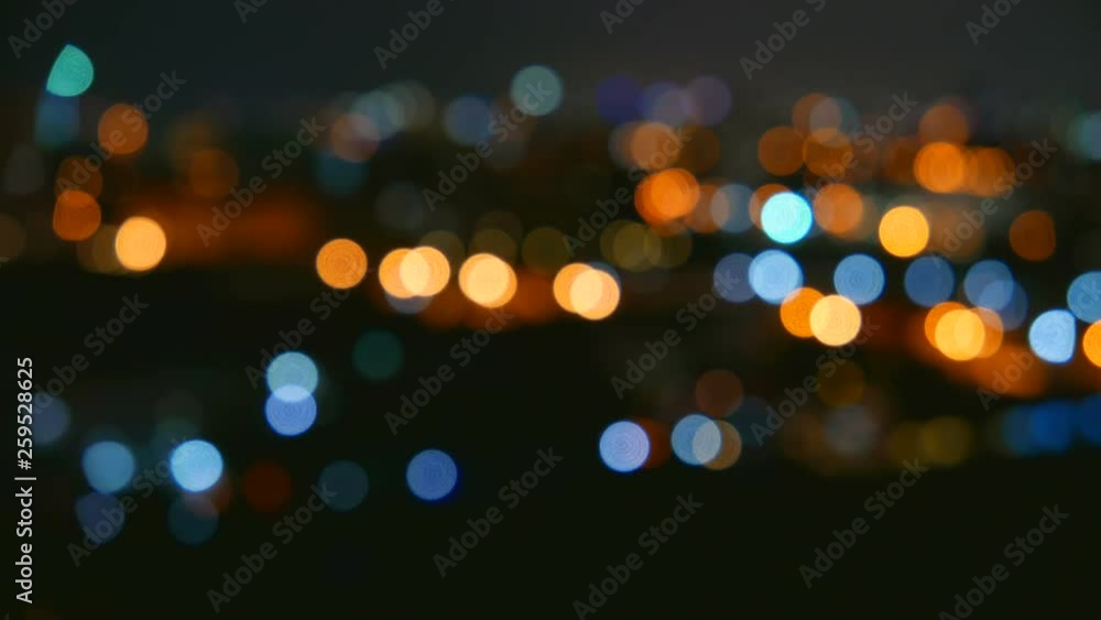 Timelapse of colorful flickering city light bokeh at night background.