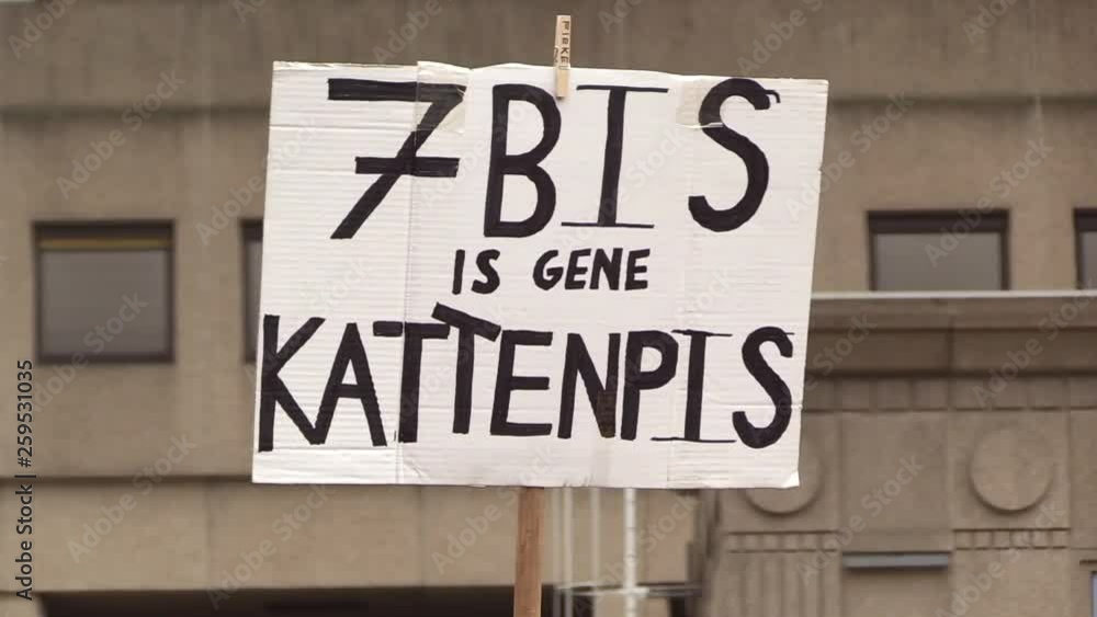 a protest cardboard raised in the air for an adjustment of the climate law, article 7 bis a protest cardboard raised in the air for an adjustment of the climate law, article 7 bis