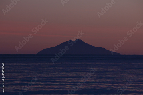 Sunset over Montecristo island from Marina di Campo beach  Elba island  Tuscany  Italy