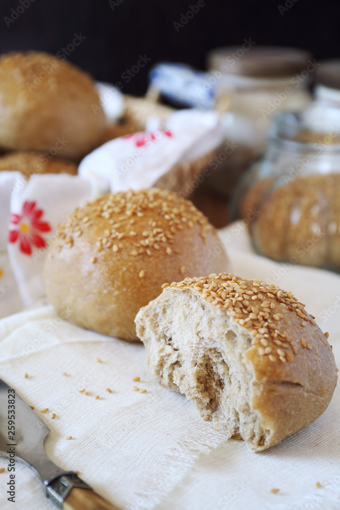 Fresh homemade sourdough bread buns with sesame Fresh homemade sourdough bread buns with sesame