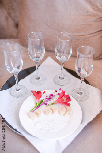 four glasses with champagne and bread on plate