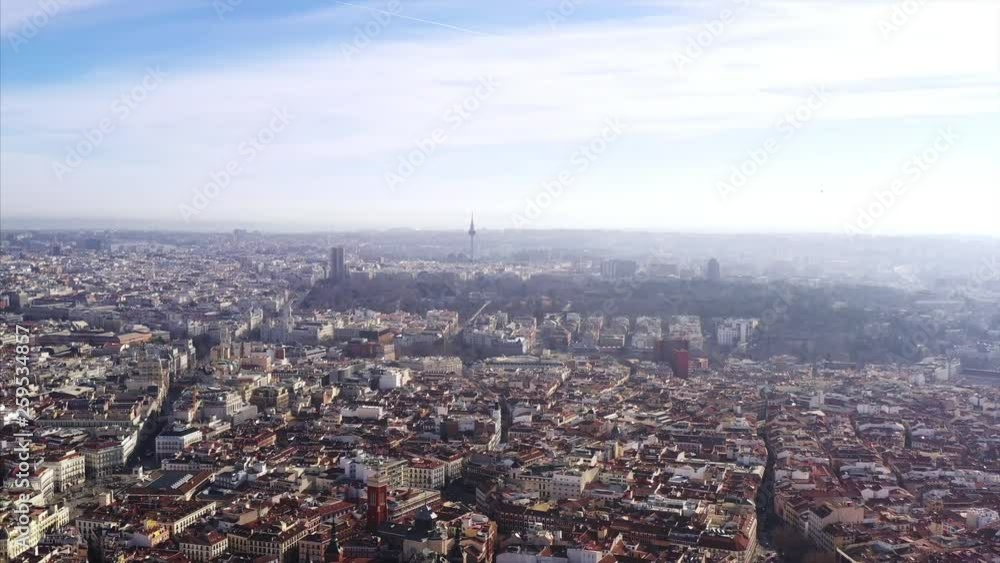 Long aerial shot of Madrid. The camera is looking down and panning showing all of Madrid: the market places, the houses, the skyscrapers, the churches and the streets. Long aerial shot of Madrid. The camera is looking down and panning showing all of Madrid: the market places, the houses, the skyscrapers, the churches and the streets.