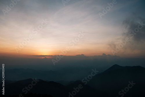 Light morning fog, sunrise and spectacular mountain ranges lined alternated beautifully. Khao Jed Yod, Trang in Thailand.