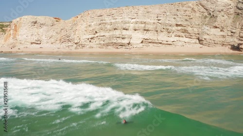 Aerial: Surfers at Sagres during a sunny day.