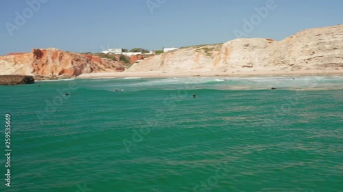 Aerial: Surfers at Sagres during a sunny day.