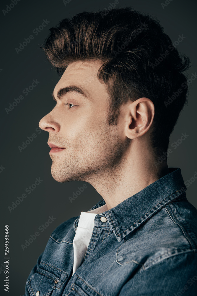 side view of handsome and brunette man in denim shirt isolated on black side view of handsome and brunette man in denim shirt isolated on black