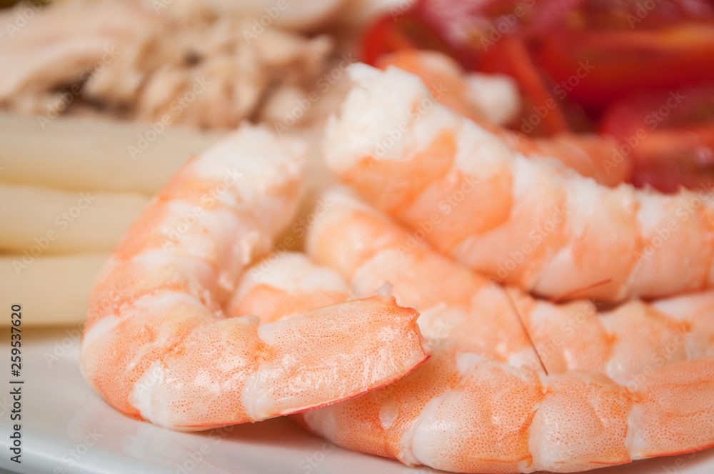 closeup of fresh shrimps with vegetables in a plate closeup of fresh shrimps with vegetables in a plate