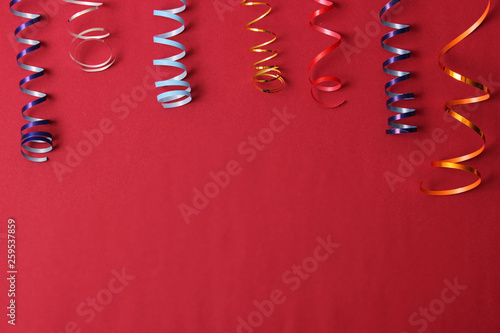  Festive background of ribbons and confetti on a colored background top view. photo