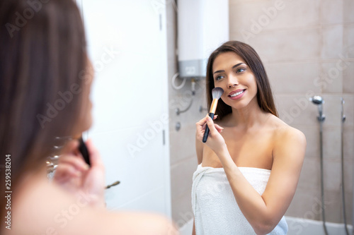 Applying gentle touches with a makeup brush