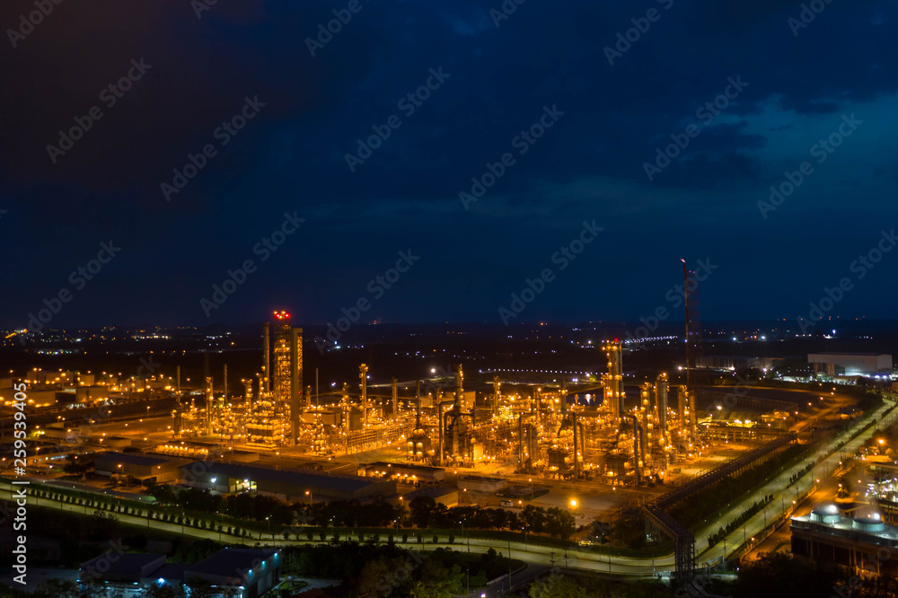 Aerial view. Oil refinery factory and oil storage tank at twilight and night. Petrochemical Industrial.