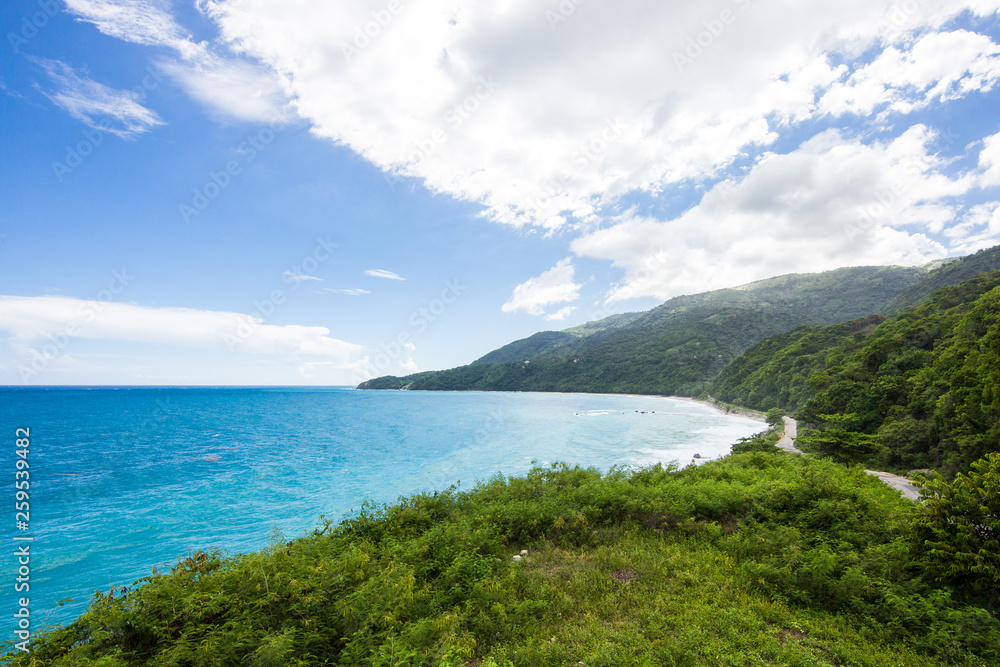 View from a cliff into the bay in the Caribbean Sea. The road in the mountains, serpentine. Tropical Island, Dominican Republic
