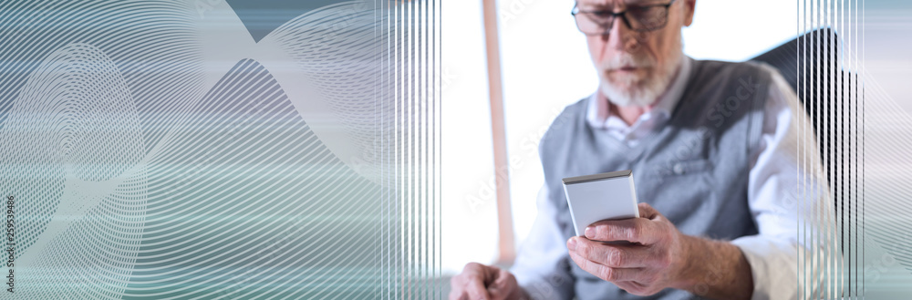 Senior businessman reading a message on his mobile phone, hard light. panoramic banner Senior businessman reading a message on his mobile phone, hard light. panoramic banner