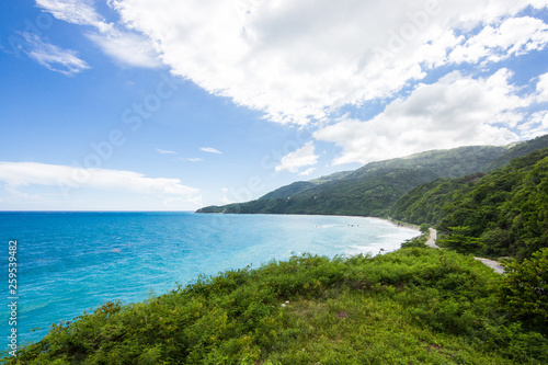 View from a cliff into the bay in the Caribbean Sea. The road in the mountains, serpentine. Tropical Island, Dominican Republic