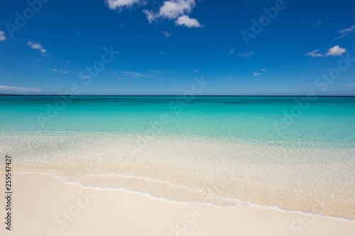 Beautiful beach with white sand and crystal clear water. No one around. Wave in the sand and blue sky. Atlantic Ocean, Dominican Republic