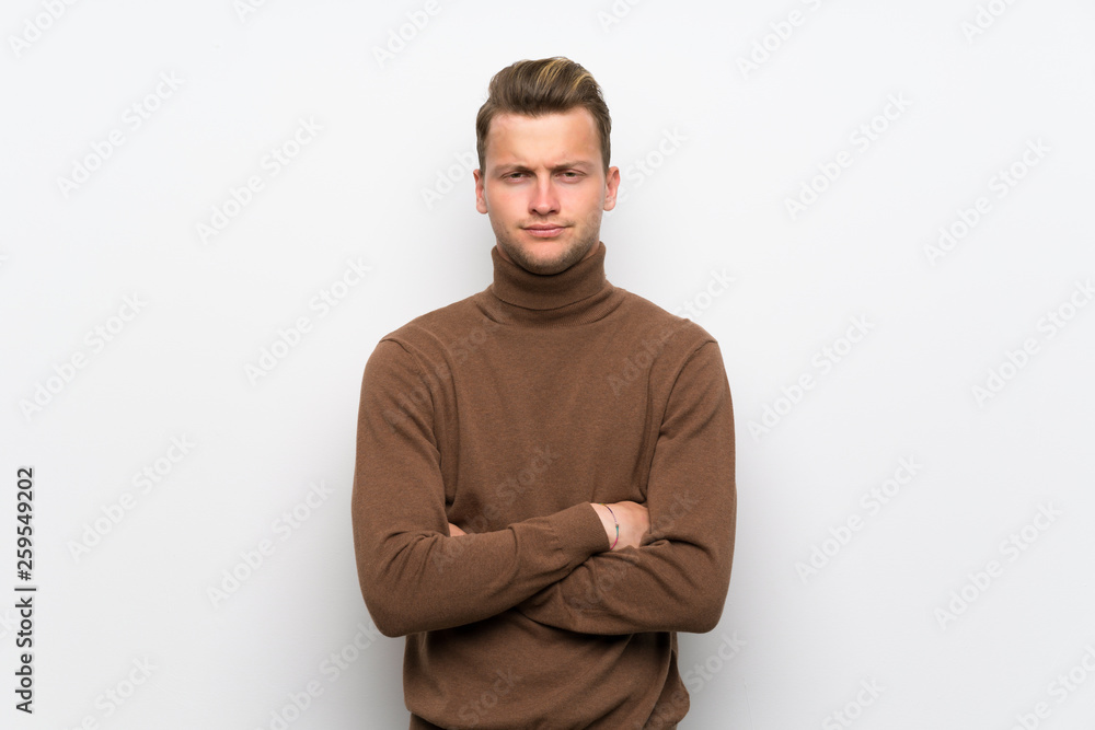 Blonde man over isolated white wall angry Blonde man over isolated white wall angry
