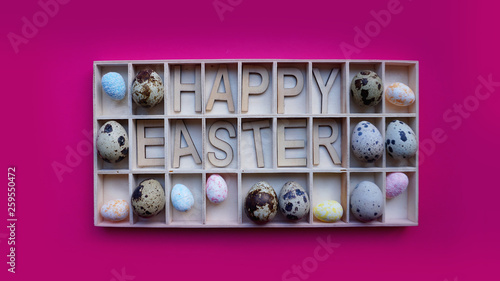 Easter eggs. Happy easter text. Holidays decoration pink background. Decor elements in wooden containers