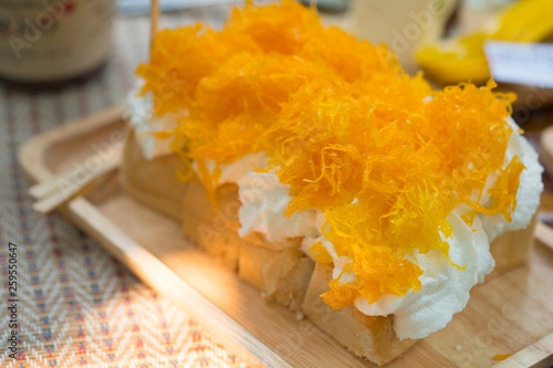 Toast with cream and gold egg yolks thread (Foythong) on top photo