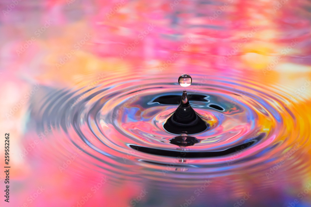 Water drop image in to colorful water Water drop image in to colorful water