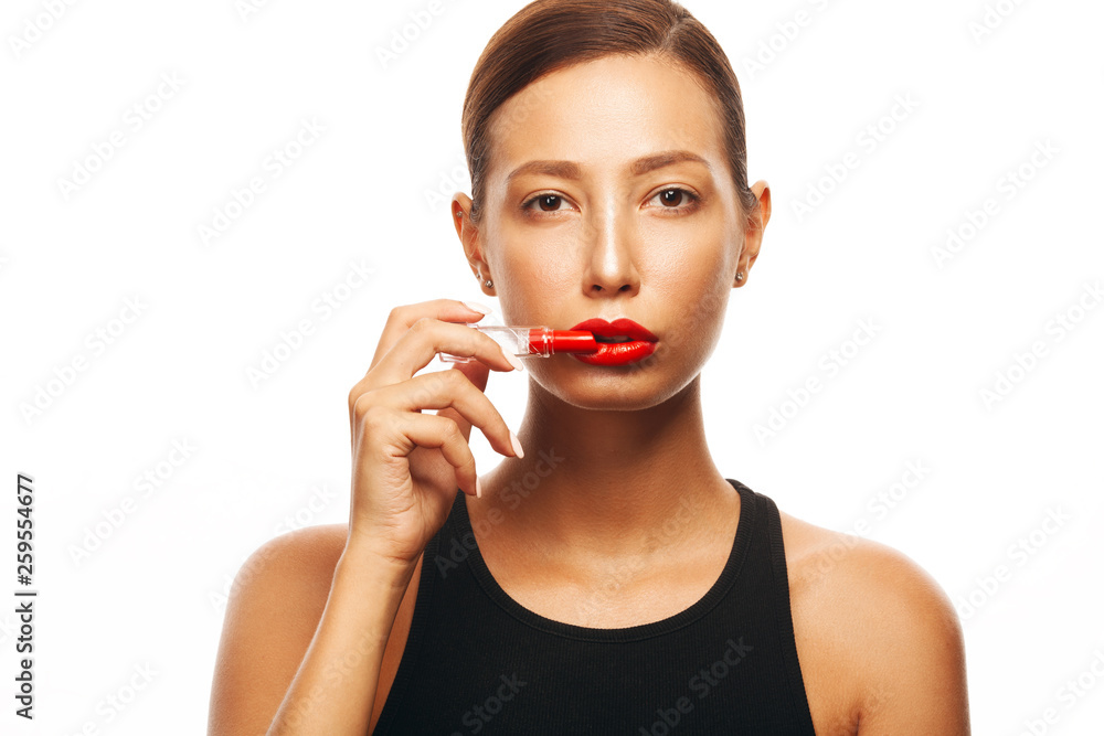Red Obsession, Beauty Cosmetics, Fashion Make-up concept. Close up portrait of charming young woman with opened lipstick in her hand. Short haircut, healthy skin. Studio shot Red Obsession, Beauty Cosmetics, Fashion Make-up concept. Close up portrait of charming young woman with opened lipstick in her hand. Short haircut, healthy skin. Studio shot
