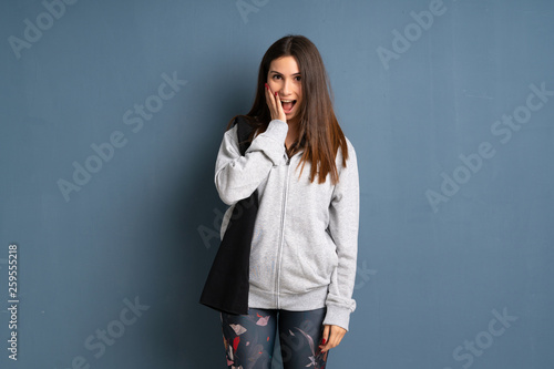 Young sport woman with surprise and shocked facial expression