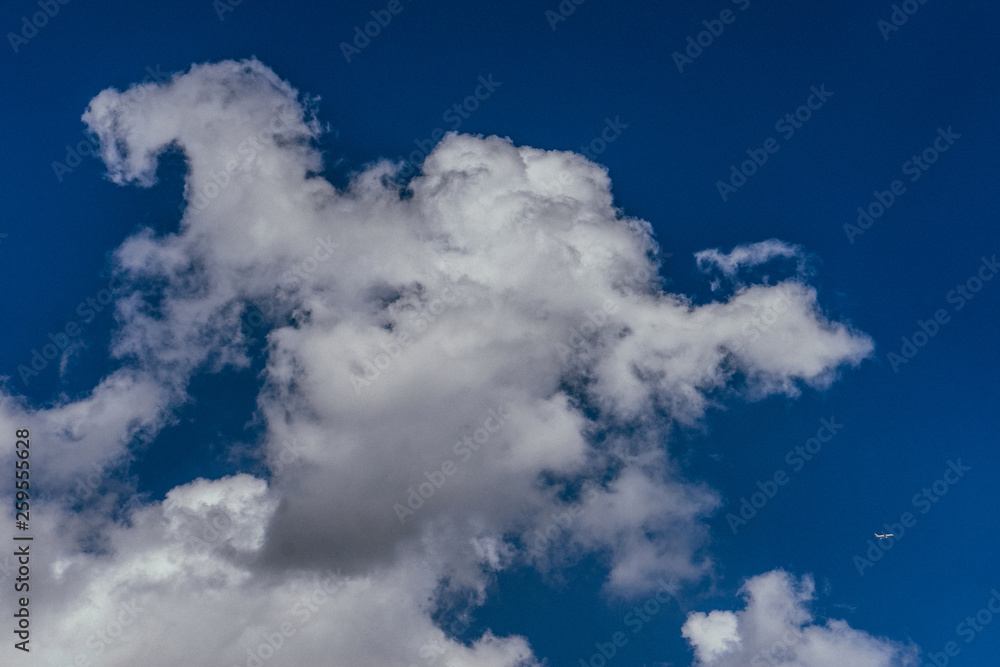 ISTANBUL, TURKEY - SEPTEMBER 2018: Big blue sky, clouds and small plane ISTANBUL, TURKEY - SEPTEMBER 2018: Big blue sky, clouds and small plane