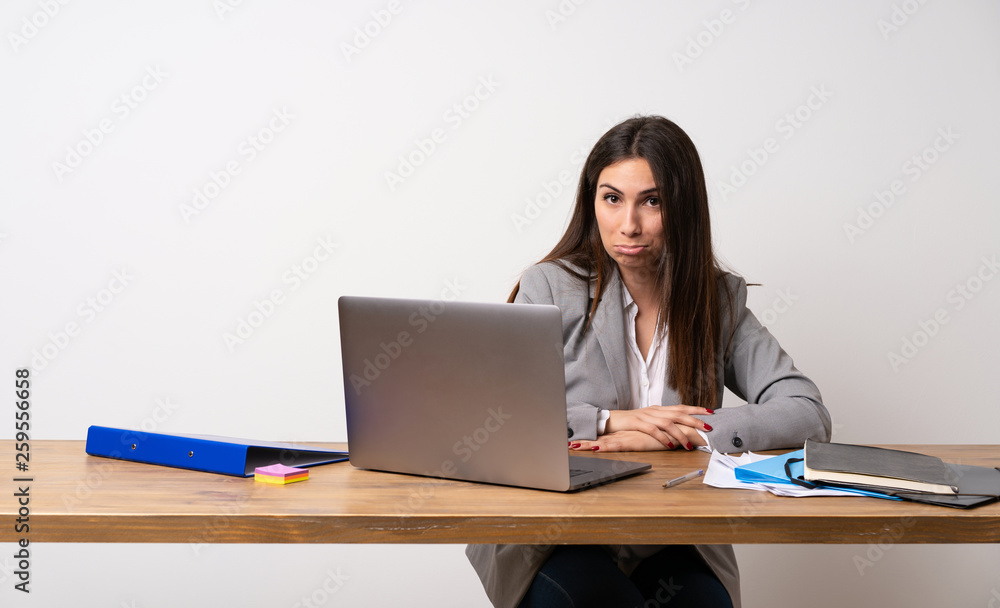 Business woman in a office with sad and depressed expression Business woman in a office with sad and depressed expression