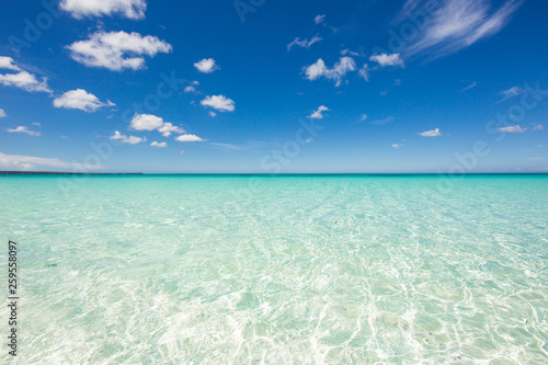 Horizon line with crystal clear water of the Caribbean Sea and blue sky with clouds. Calm and relaxation. Beautiful background. Dominican Republic  Barahona Bahia de las Aguilas. Best beaches 
