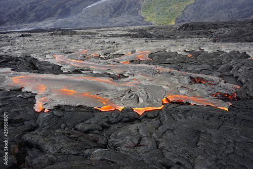 Lava field with new hot flowing lava in Big Island in Hawaii
