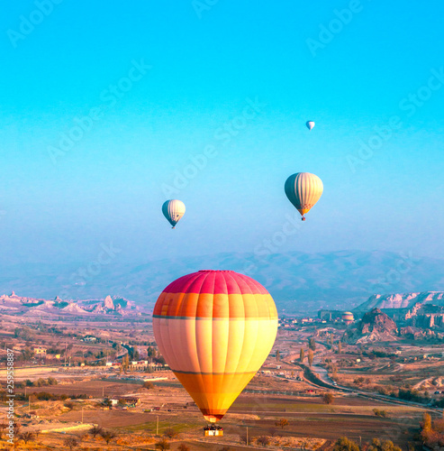 Hot air balloons flying at dawn over the valley of Cappadocia in Turkey. Close up view.