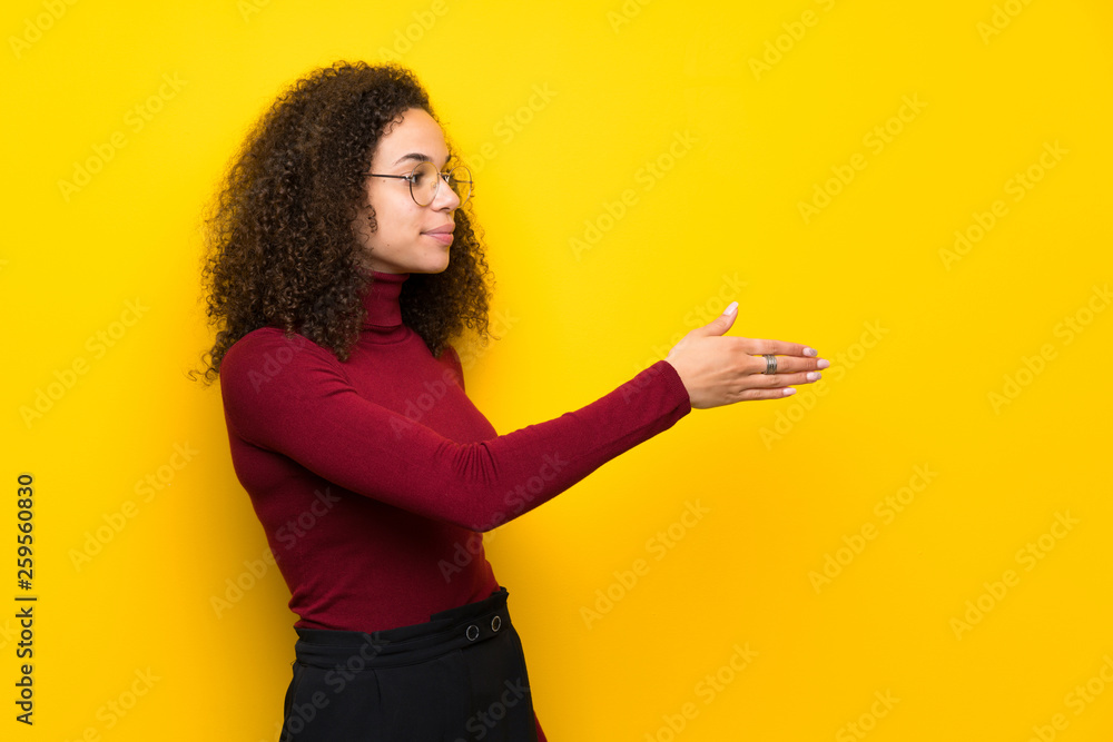 Dominican woman with turtleneck sweater handshaking after good deal Dominican woman with turtleneck sweater handshaking after good deal