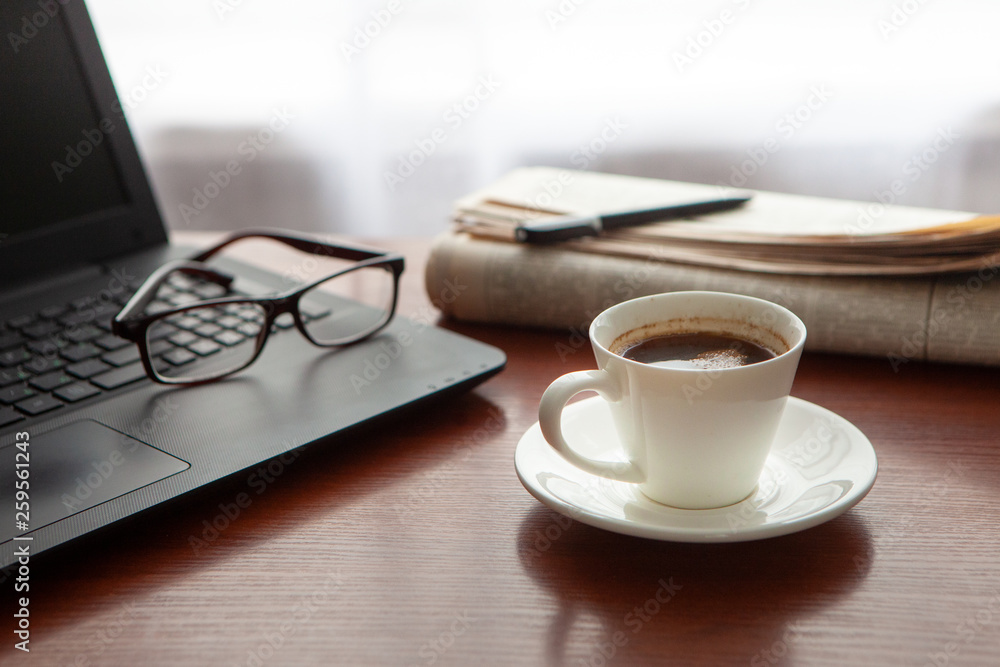 Newspaper with computer on table. Coffee break. Newspaper with computer on table. Coffee break.