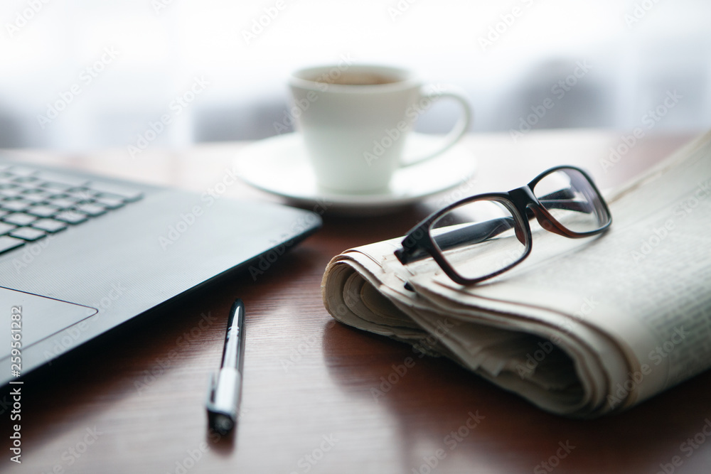 Newspaper with computer on table. Coffee break. Newspaper with computer on table. Coffee break.