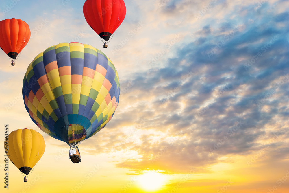 Fototapeta premium Colorful balloons floating in the sky at sunset.
