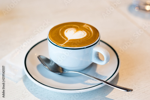 Takadanobaba, Japan, 03/23/2019 , Macchiato coffee, with a heart decoration on top with the creamy silky milk, on an italian restaurant. photo