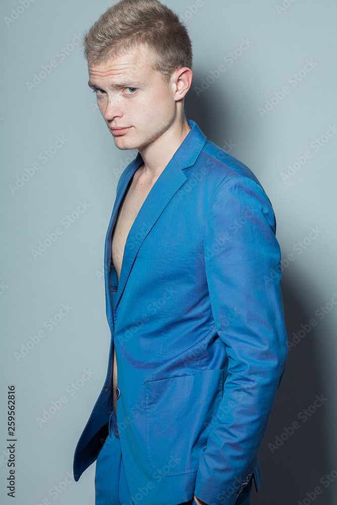 Male beauty concept. Portrait of young man with perfect haircut wearing blue  classic jacket. Hollywood star style. Blue-eyed boy with blond hair. Studio  shot Stock Photo | Adobe Stock