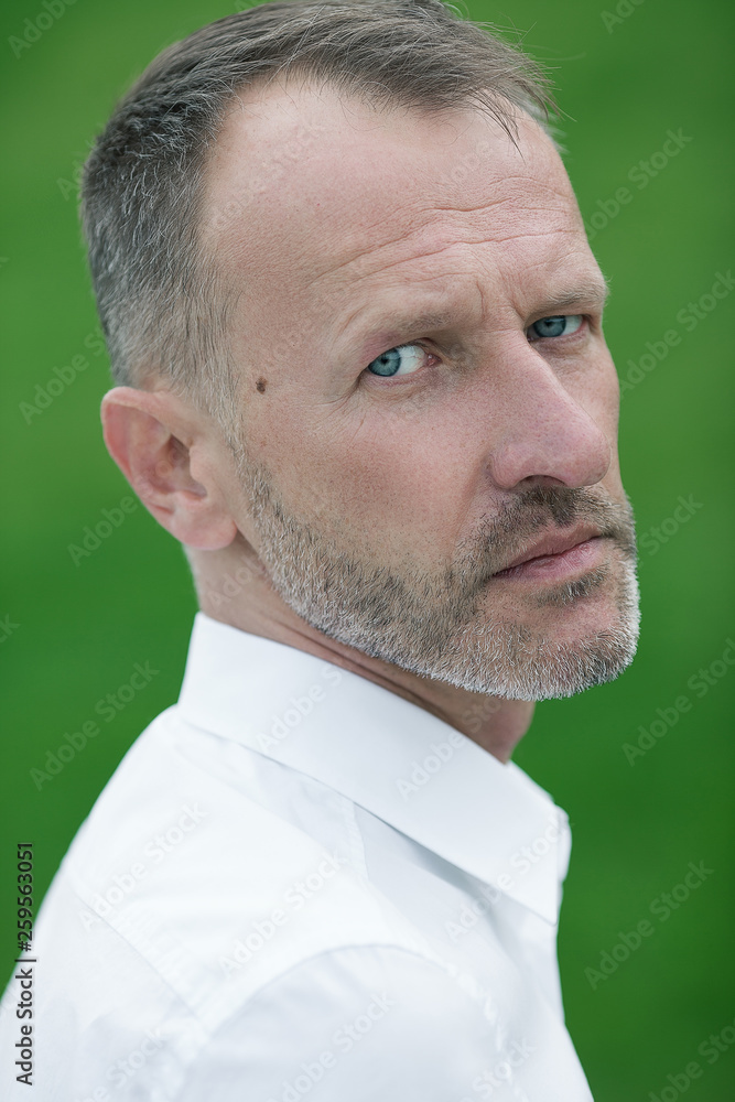 Fabulous at any age. Portrait of 45-year-old man standing over green grass  background in white shirt. Close up. Classic style. Gray hair. Outdoor shot  Stock Photo | Adobe Stock