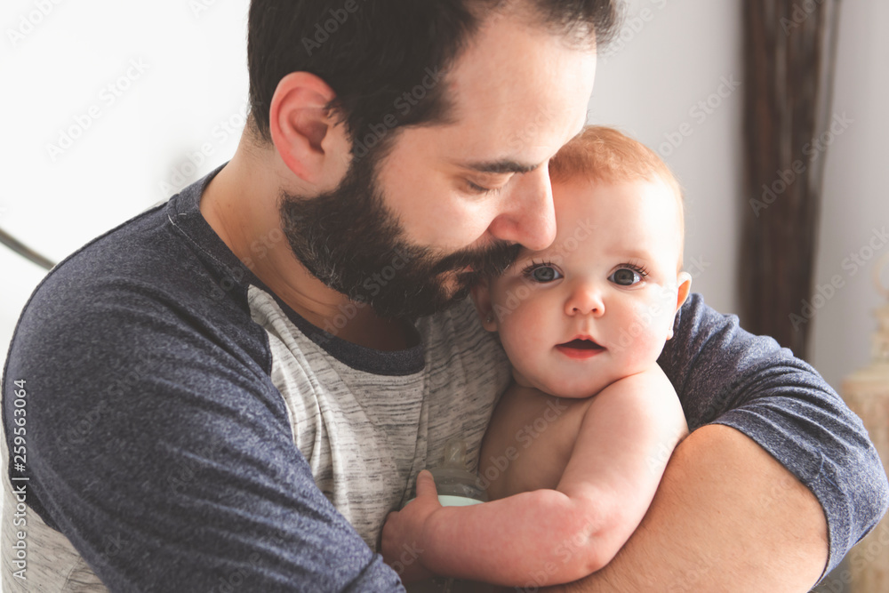 A Nice and protect father with baby on bed A Nice and protect father with baby on bed