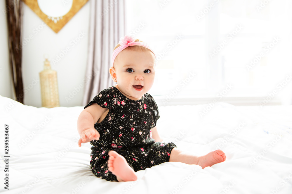 Baby girl in white bedding at home look nice Baby girl in white bedding at home look nice