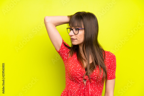 Young woman over green wall laughing