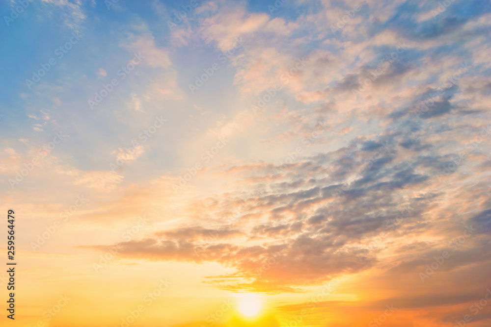 Fototapeta premium Sky blue and orange light of the sun through the clouds in the sky