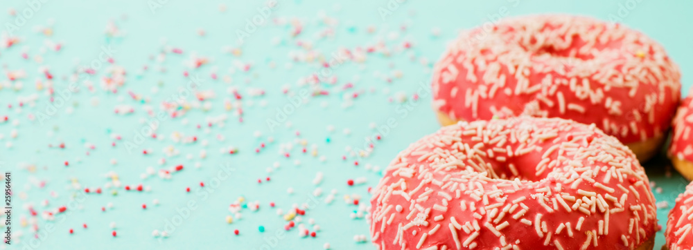 Donuts decorated with icing on blue background. Donuts decorated with icing on blue background.