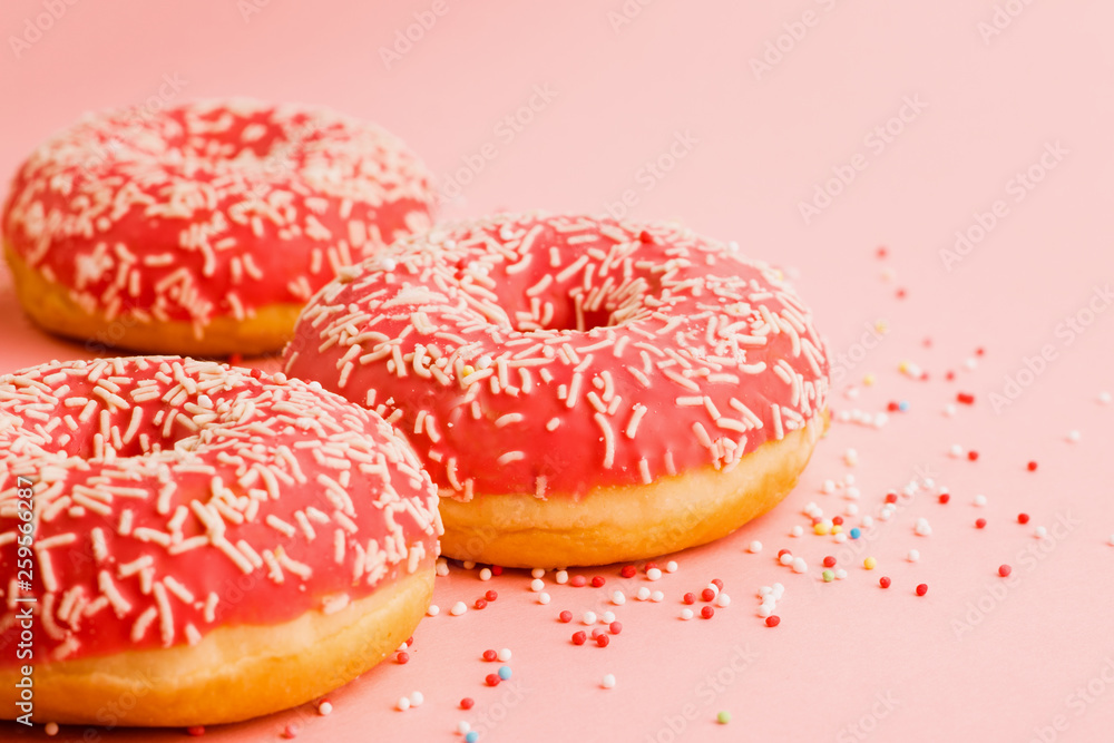 Coral donuts. Donuts decorated with icing on pink background. Coral donuts. Donuts decorated with icing on pink background.
