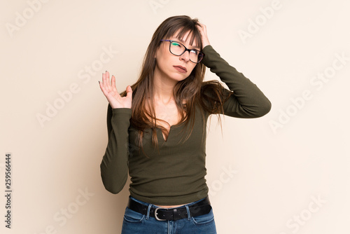 Young woman on ocher background frustrated by a bad situation