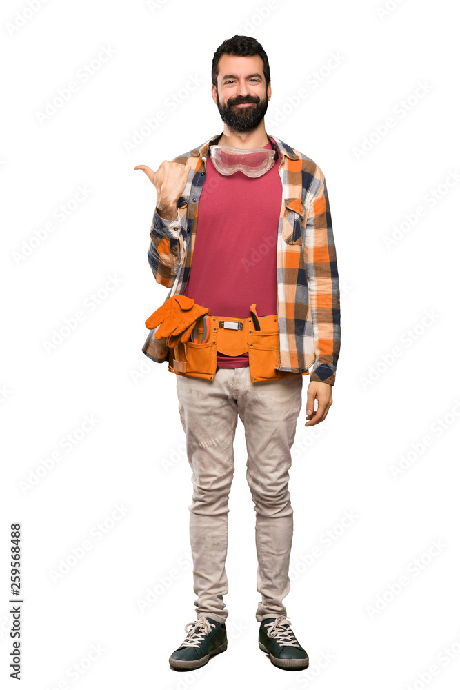 Craftsmen man pointing to the side to present a product over isolated white background Craftsmen man pointing to the side to present a product over isolated white background