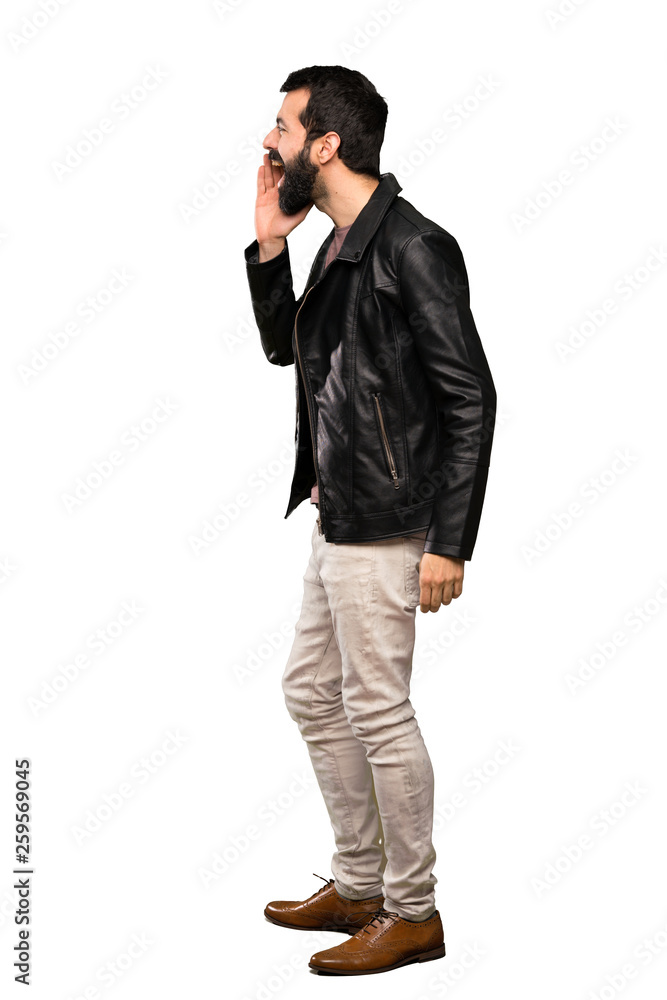 Handsome man with beard shouting with mouth wide open to the lateral over isolated white background Handsome man with beard shouting with mouth wide open to the lateral over isolated white background