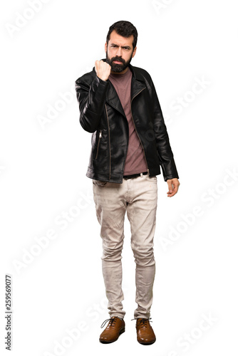 Handsome man with beard with angry gesture over isolated white background