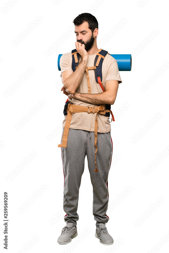 Hiker man having doubts over isolated white background Hiker man having doubts over isolated white background